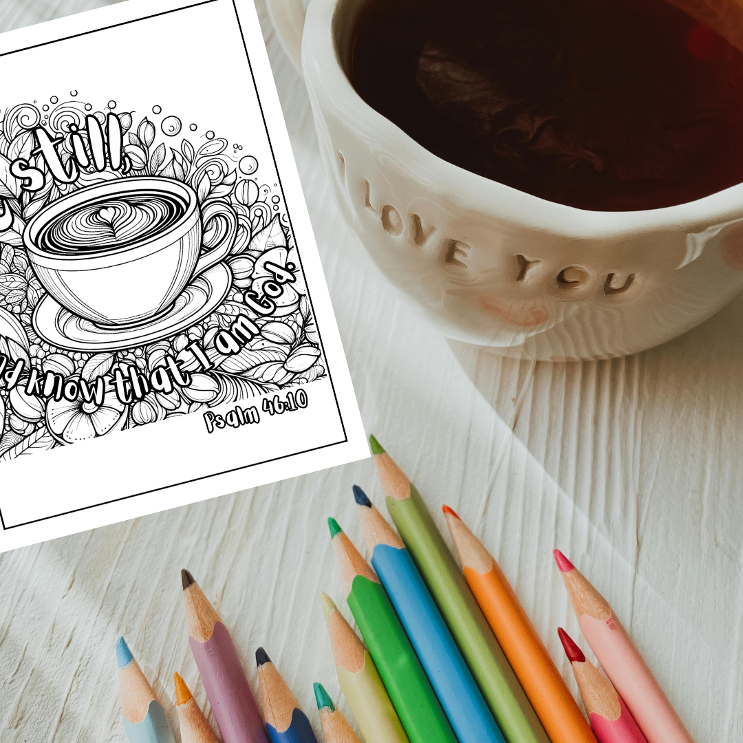 Cup of coffee, coloring book page with coffee design, and colored pencils on a wooden surface.