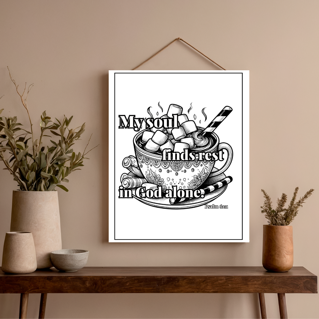 Framed artwork with a cup of hot chocolate and marshmallows on a beige wall above a wooden console table.
